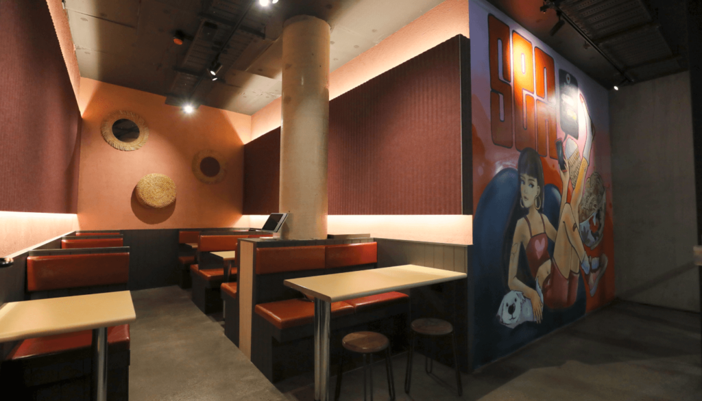 Large custom graffiti wall mural, bespoke seating booths and strip LED lighting for this hospitality fit out for Senn Noods, Total Fitouts Canberra North